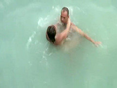 Tattooed nudist fucked in the water