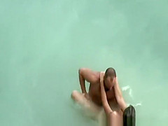 Tattooed nudist fucked in the water