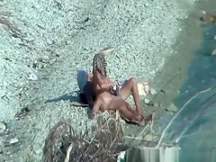 Two nudist couples spied at rocky beach