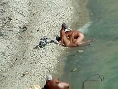 Two nudist couples spied at rocky beach