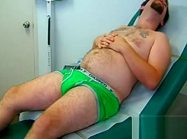 Young beer-bellied stud examined by doctor